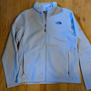 The North Face zip up sweater. Silver color. Blue logo. Size Medium.